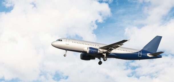 Modern airplane flying in a cloudy sky